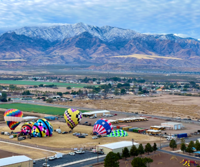 A bunch of hot air balloons are in the sky