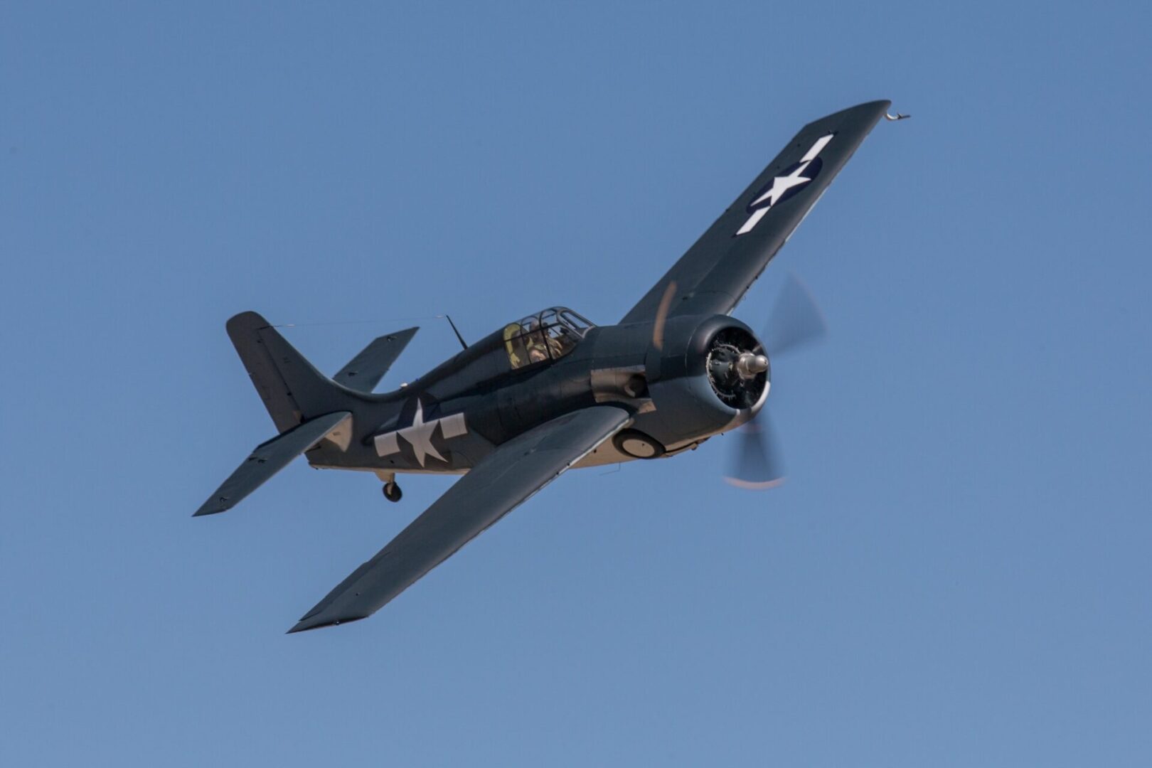 A small plane flying in the sky with propellers.