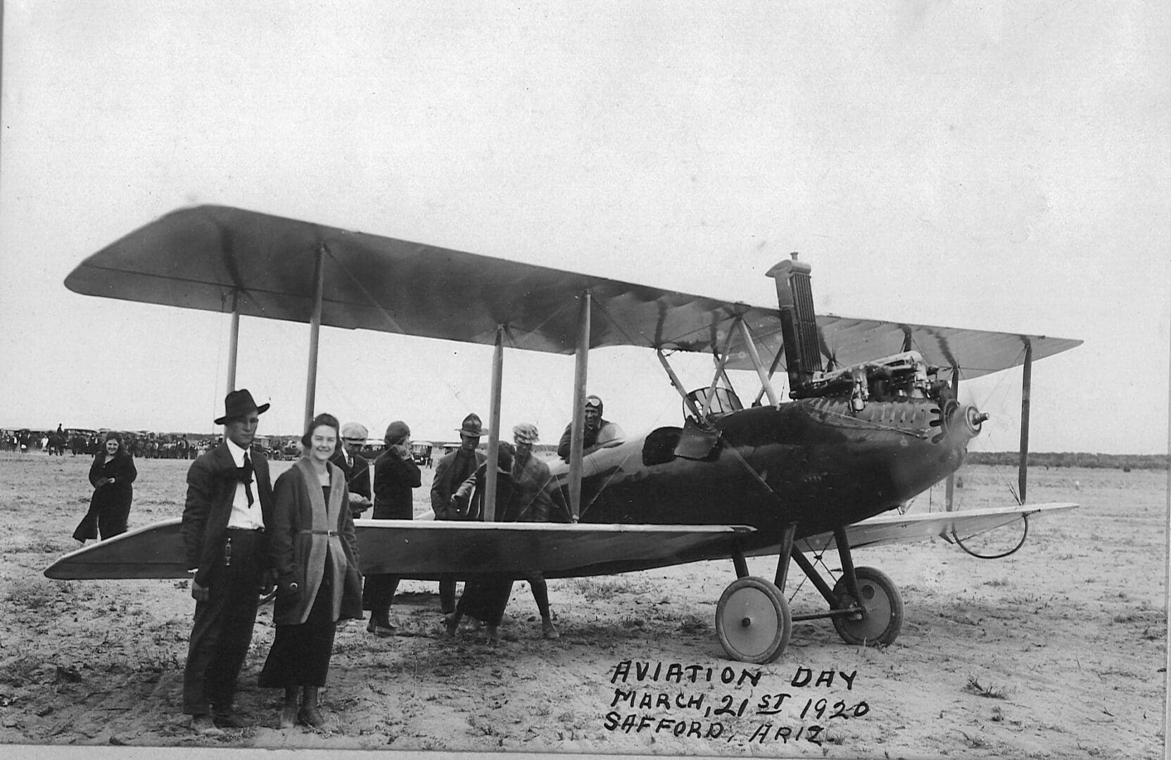 A group of men standing next to an airplane.