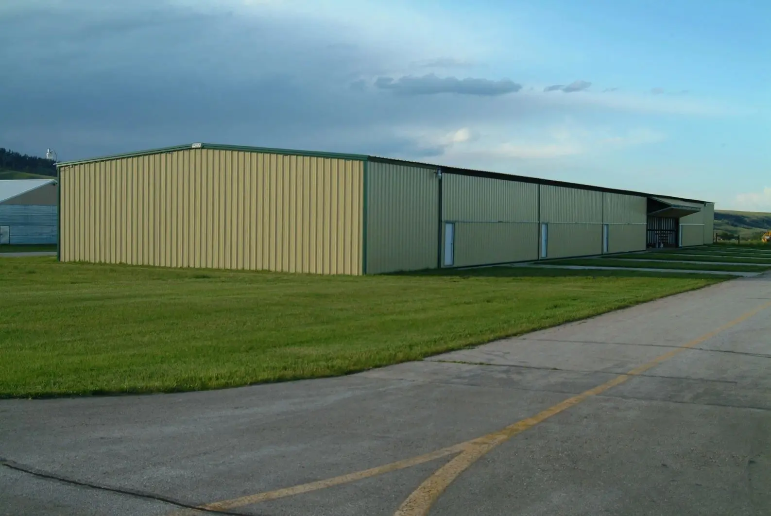 A large building with a lot of grass on the side.