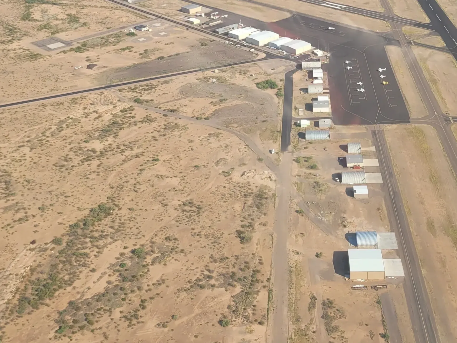 An aerial view of a runway and some buildings.