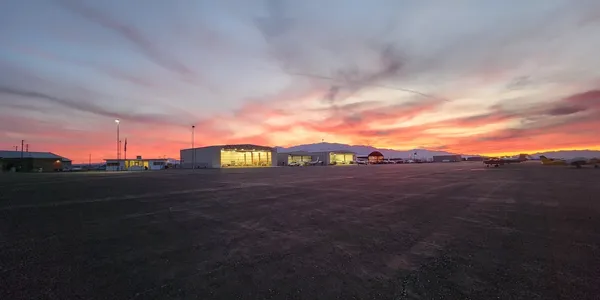 A large field with a building in the middle of it