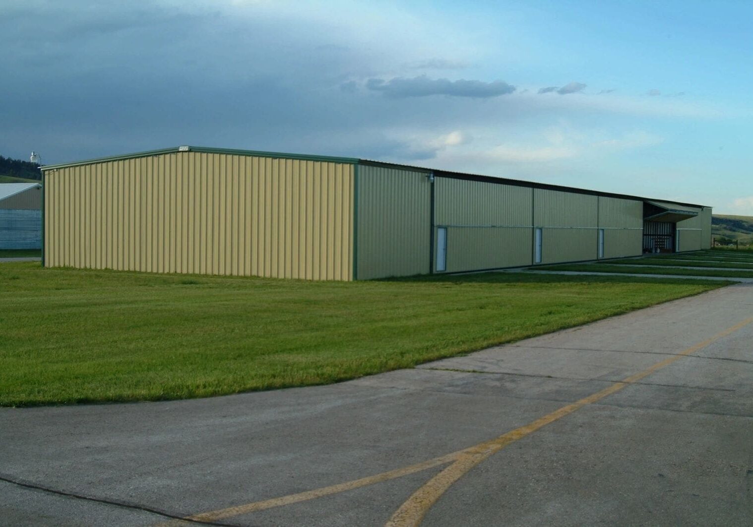 A large building with a lot of grass on the side.